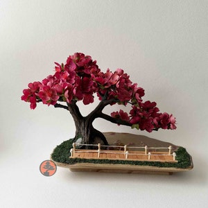 Artificial Japanese Garden Scene with burgundy blossom bonsai, bridge, and koi pond