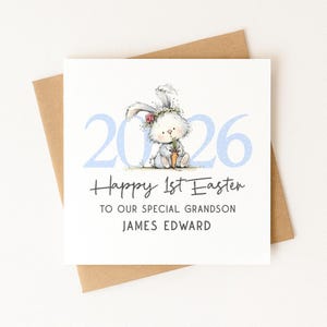 May include: A square greeting card with a watercolor illustration of a bunny holding a carrot, with the text "Happy 1st Easter" and "2026". The card is on a brown envelope.