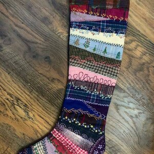 May include: A colorful patchwork Christmas stocking with a variety of fabrics and textures. The stocking is made of recycled materials and features a unique design.