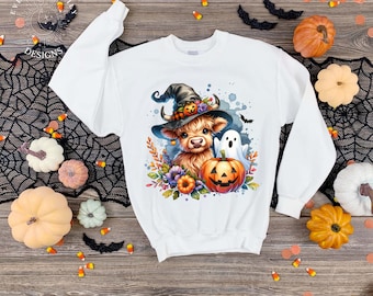 May include: White sweatshirt featuring a Halloween-themed graphic. The design includes a Highland cow wearing a witch hat, a jack-o'-lantern, and a ghost. The sweatshirt is surrounded by colorful flowers and bats, perfect for the spooky season.