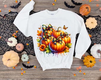 May include: White sweatshirt featuring a vibrant watercolor design of pumpkins with colorful bows, leaves, and butterflies. The design includes orange, green, and yellow hues, perfect for autumn or Halloween. The sweatshirt is surrounded by decorative pumpkins and Halloween accents.