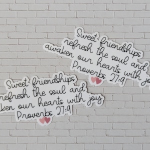 May include: Two white stickers with black text and pink hearts. The text reads "Sweet friendships refresh the soul and awaken our hearts with joy Proverbs 27:9".
