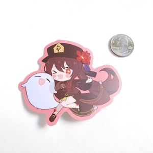 May include: A sticker featuring a cartoon character with brown hair, wearing a red and gold hat, a red flower, and a black and brown outfit. The character is holding a white ghost with a pink blush. The sticker is on a white background.