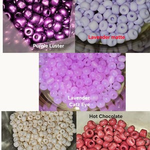 May include: An assortment of colorful beads in various shades. The image displays purple luster, lavender matte, lavender catz eye, cream, and hot chocolate beads. These beads are suitable for jewelry making and crafting projects.