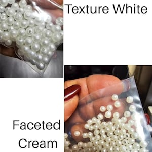 May include: Two clear plastic bags filled with white and cream-colored beads. One bag contains round, textured white beads, and the other contains faceted cream beads. The text "Texture White" and "Faceted Cream" are visible.