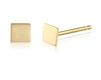 May include: A pair of gold square stud earrings. The earrings are simple and minimalist in design.