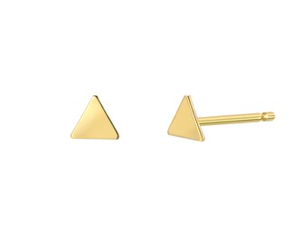 May include: A pair of gold triangle stud earrings. The earrings are simple and minimalist, making them a versatile accessory for any occasion.