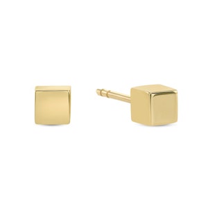 May include: A pair of gold square stud earrings. The earrings are simple and minimalist, and they would make a great everyday accessory.