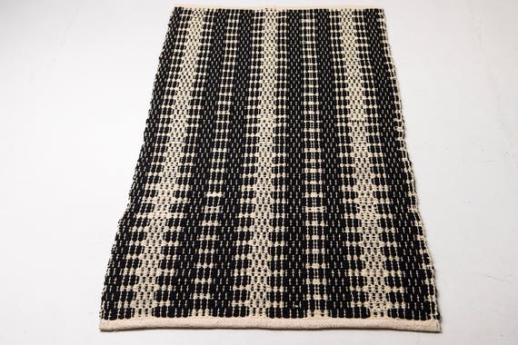 Black and white scandinavian rug weaving on the loom machine | Etsy
