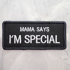 May include: Black embroidered patch with white stitching that reads "Mama Says I'm Special".