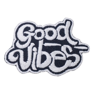 May include: White embroidered patch on a dark blue background with the text "Good Vibes" in a stylized font.