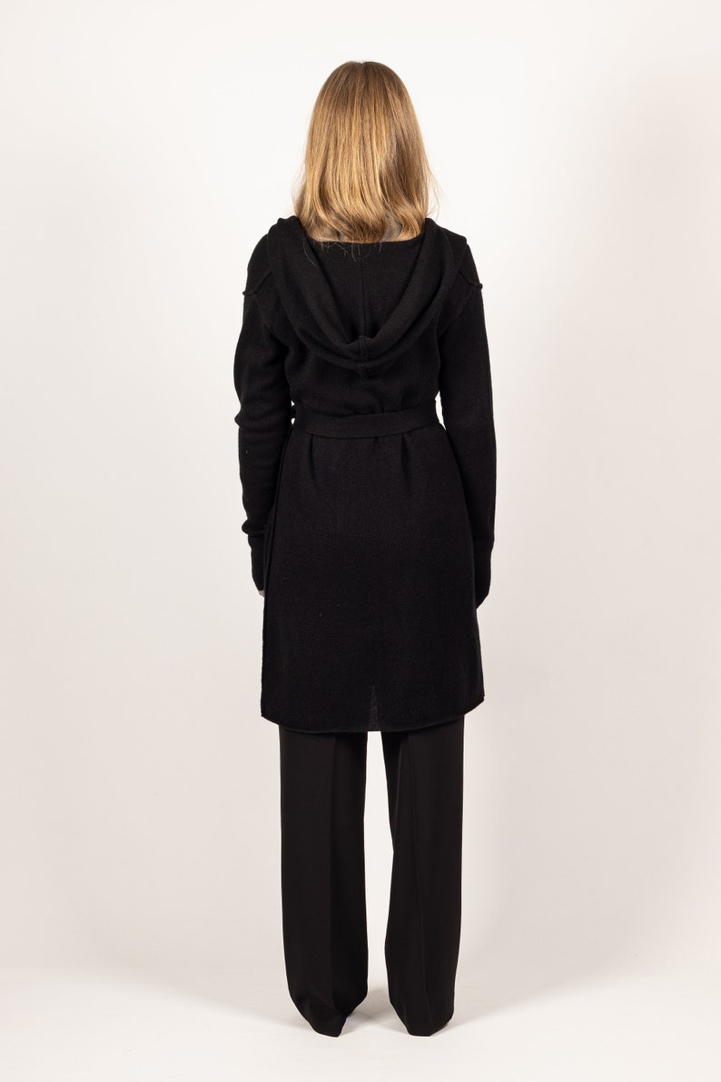Drape yourself in elegance with Krista Elsta's EDITH black hooded cashmere cardigan or jacket, a sophisticated and long outerwear piece.