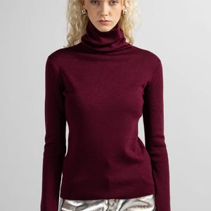 Burgundy wool pullover with a simple design, showcasing the rich red color and soft material.