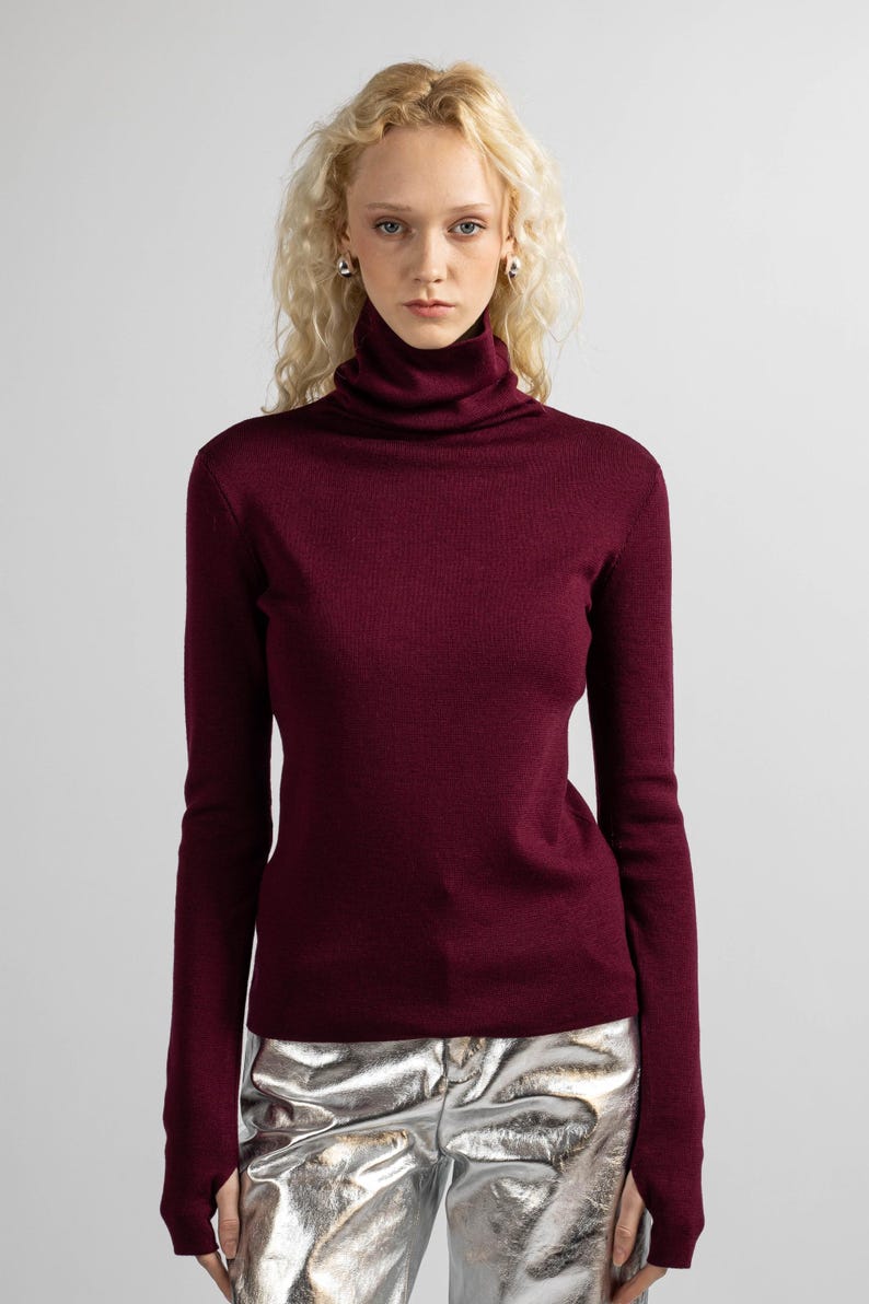 Burgundy wool pullover with a simple design, showcasing the rich red color and soft material.