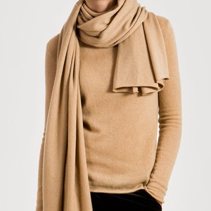 Soft beige cashmere scarf folded showing fine knit texture