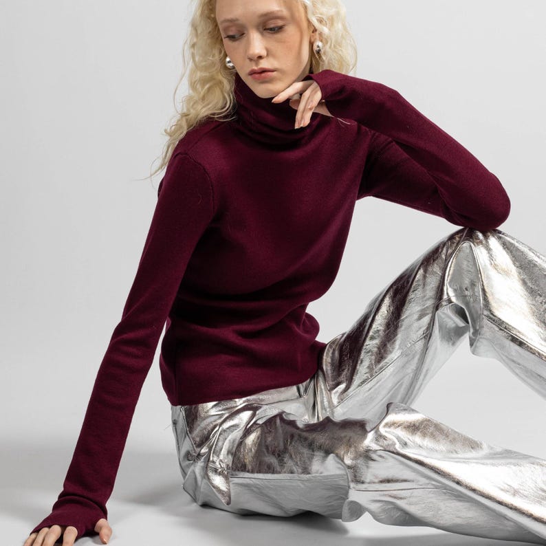 High neck merino wool pullover in deep burgundy, designed for comfort and warmth.