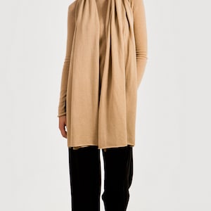Cashmere travel wrap styled with jeans and sweater