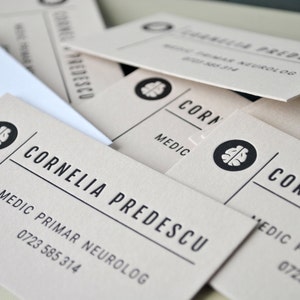 100 cartes de visite typographiques, papier cartonné marron clair, encre noire. Votre texte, nos cartes de visite typographiques design. Découpe de forme personnalisée