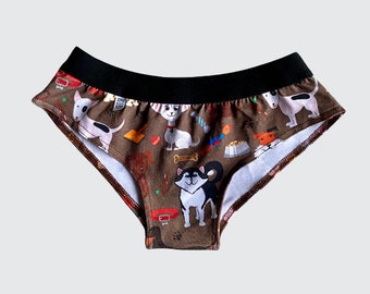 May include: Brown cotton underwear with a black waistband and a print of various dogs and dog-related items.