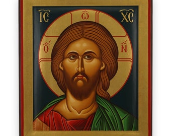 Pode incluir: Ícone religioso com um retrato de um homem com cabelo castanho comprido e barba, contra um halo dourado. O ícone tem um fundo escuro, com vestes vermelhas e verdes. A moldura é dourada e vermelha.
