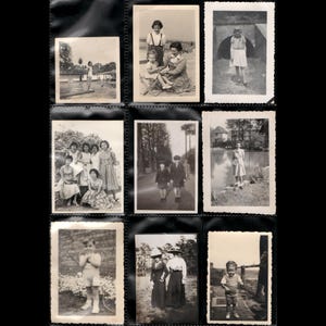 May include: A black photo album page filled with nine vintage black and white photographs. The photos depict various scenes, including people posing, children playing, and outdoor settings. The album is a nostalgic collection of memories.