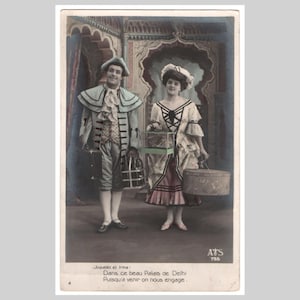 Postal vintage con foto real - Pareja romántica, regalo, jaula de pájaros, maleta, glamour - Tarjeta de felicitación francesa eduardiana antigua, coloreada a mano, 1905