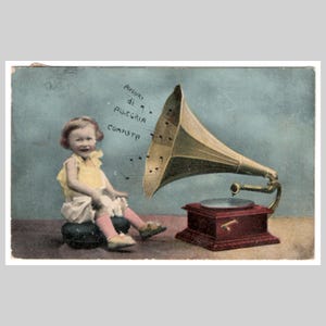 May include: Vintage postcard featuring a child seated near a gramophone. The gramophone has a large horn and a red base. The child is wearing a yellow dress and pink socks. Text on the postcard reads "Auguri di Allegria Completa."