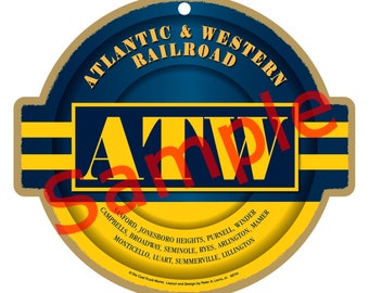 May include: A round, gold-coloured sign with the text "Atlantic & Western Railroad" in a black circle with a blue background. The letters "ATW" are in a yellow circle with a blue background. The sign lists the towns served by the railroad.