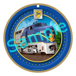 May include: A blue and silver model train engine with the number 1216 on the side. The train is on a circular blue background with gold accents and a gold circle with the text "The D&H" in a yellow shield.