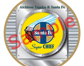 May include: A circular metal ornament with the Santa Fe Super Chief logo. The logo features a Native American profile, the words "Santa Fe" and "Super Chief", and the text "Atchison Topeka & Santa Fe". The ornament has a gold border.