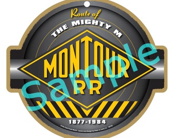 May include: A round, grey and yellow railway sign with the text "Route of The Mighty M MonTOUR RR 1877-1984".