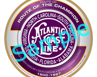 May include: A purple and gold circular emblem with the text "Route of the Champion" and "Atlantic Coast Line" in a white circle. The text "Virginia-North Carolina-South Carolina-Georgia-Florida-Alabama-Florida" surrounds the circle. The text "1900-1967" is at the bottom of the emblem.