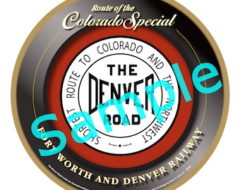 May include: A round, red, white and black sign with the text "Route of the Colorado Special" and "The Denver Road" in a circle. The sign also says "Shortest Route to Colorado and the Northwest" and "Fort Worth and Denver Railway".