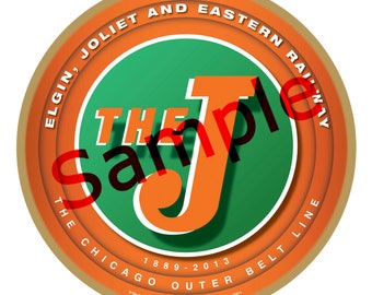 May include: A round, brown, wooden ornament with a gold rim. The ornament features a green circle with a large orange letter "J" inside. The text "The Elgin, Joliet and Eastern Railway The Chicago Outer Belt Line 1889-2013" is printed around the outer edge of the ornament.
