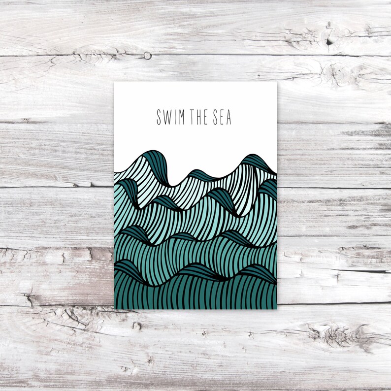 May include: A white card with the text "SWIM THE SEA" printed in black. The card features a graphic of teal blue and black waves.