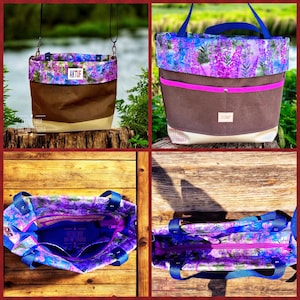 May include: A tote bag with a floral pattern in purple, blue, and white. The bag has a brown body and a cream-colored bottom. It features blue handles and a pink zipper. The text "AKTUF" is visible on the front.