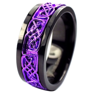 May include: A black and purple ring with a Celtic knot design. The ring is made of stainless steel and has a polished finish.