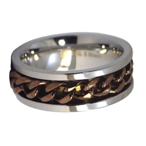 May include: A silver and copper ring with a chain design. The chain is made of copper and is set into the silver band.