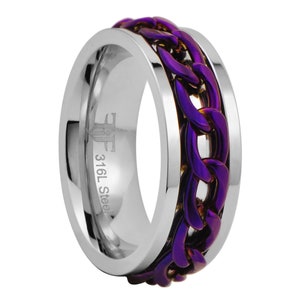 May include: A stainless steel ring with a purple and gold chain design. The ring is engraved with "316L Steel".