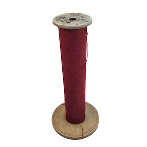 May include: A wooden spool with a red thread wound around it. The spool has a wooden base and a top with holes.