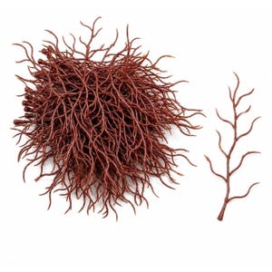 May include: A large cluster of dark brown, thin, branching plastic twigs alongside a single detached twig. Each piece features a central stem with multiple curved, slender offshoots extending outward, mimicking the appearance of bare tree branches.