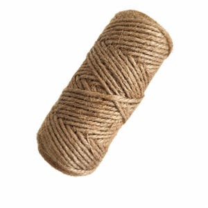 May include: A cylindrical spool of natural brown jute twine featuring a tightly wound, multi-layered rope construction with a visible fibrous texture. The thick, rustic cord is coiled in a continuous pattern, creating a dense, sturdy bundle.