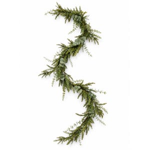 May include: A decorative garland featuring a mix of dark green pine-like needle branches and lighter sage green eucalyptus leaves. The foliage is arranged in a winding, S-shaped pattern, creating a dense and textured botanical display.