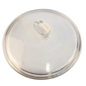 May include: A clear glass lid with a rounded shape and a small, oval-shaped handle. The lid is designed to fit on a pot or pan. The glass is transparent, allowing visibility of the contents.