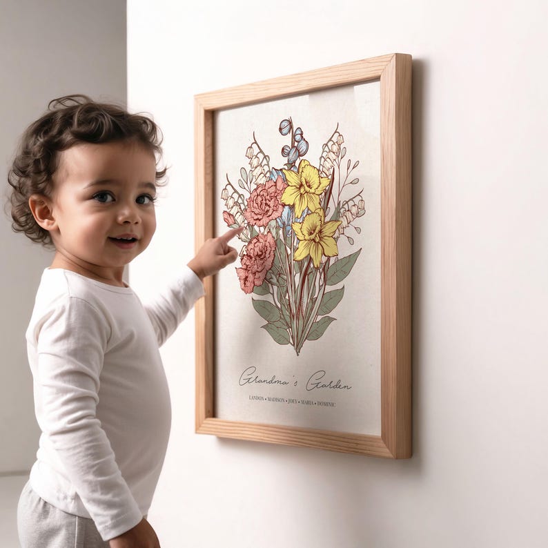 May include: A framed floral print featuring a bouquet of pink, yellow, and blue flowers. The artwork, in a light wood frame, is titled "Grandma's Garden" and includes additional text at the bottom. A child points at the artwork.