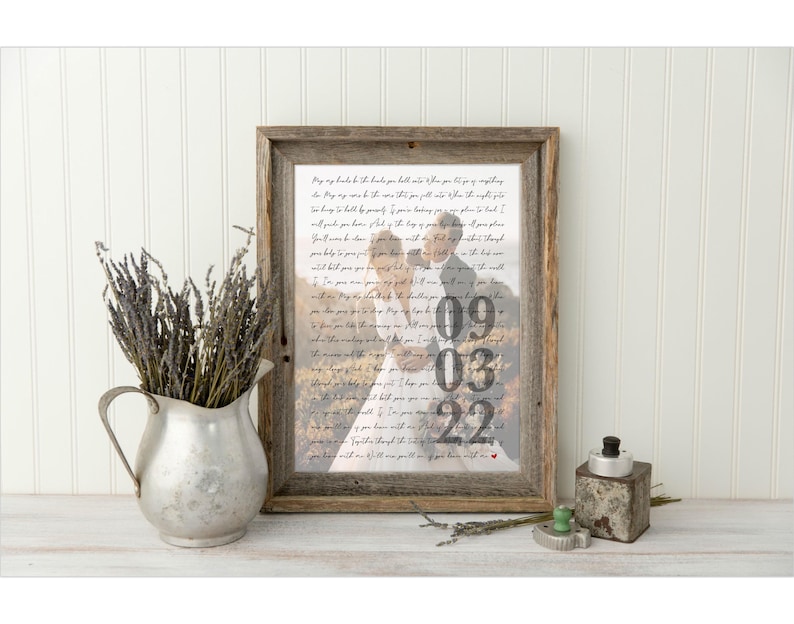 May include: A framed print with a handwritten message and a photo of a wedding couple. The date "09.03.22" is visible in the photo.