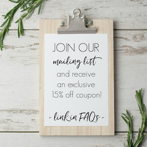 May include: A white clipboard with a wooden frame and a silver clip. The clipboard has a white paper with black text that reads "JOIN OUR mailing list and receive an exclusive 15% off coupon! - link in FAQ's -"