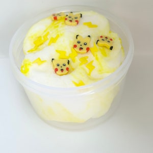 May include: A clear plastic container filled with white and yellow slime with small yellow lightning bolt and Pikachu character charms.