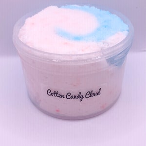 May include: A clear plastic container filled with a pink and blue fluffy substance. The container has a label that reads "Cotton Candy Cloud".