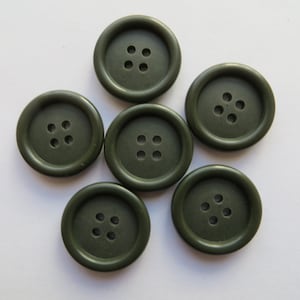 May include: Six dark green plastic buttons with four holes each.